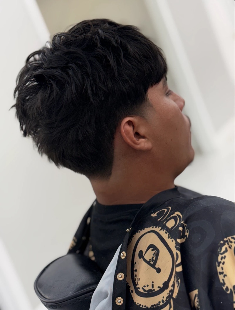 Side view of a taper with a messy textured crop on top